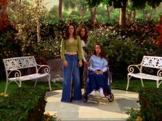 two women standing next to each other in front of trees and flowers with an inspirational quote