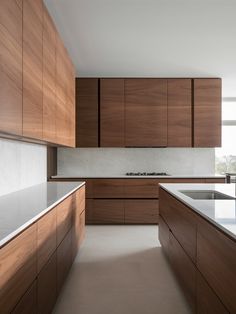 a kitchen with wooden cabinets and white counter tops