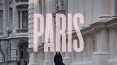 a woman is walking down the street in paris