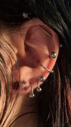 a woman with piercings on her ear