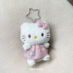 a hello kitty keychain with a pink dress on it