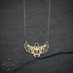 "Geometric scarab Egyptian necklace- Our cutout geometric style scarab beetle pendant necklace can be a wonderful symbol of a new start or renewal. ★This is the gold item, for the silver item use this link: https://www.etsy.com/listing/774345738 ♥WANT TO MAKE IT PERSONAL? ♥ Add a charm letter to your necklace - Add this item: https://www.etsy.com/il-en/listing/687931684 ★ Comes in our signature box, ready for gift giving. ★ Available in Gold [18K goldfield & gold plated brass ] ★ Pendant siz Scarab Egyptian, Beetle Necklace, Scarab Pendant, Geometric Origami, Jewelry Design Studio, Hamsa Earrings, Egyptian Necklace, A New Start, Scarab Beetle