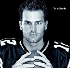 a black and white photo of a man holding a football