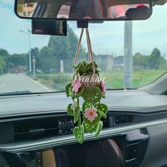 a car dashboard with flowers hanging from the dash board