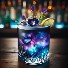 a glass filled with purple flowers and lemon wedges