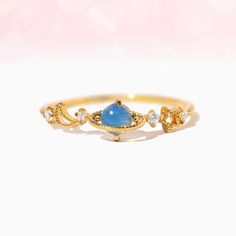 Take a ride with us to outer space in our Juno Ring. This ring features a petite, blue planet set on a band adorned with tiny CZs. Planet Ring, Blue Planet, Juno, Outer Space, 18k Rose Gold, Rose Gold Plates, Planets, Take A, Gold Rings