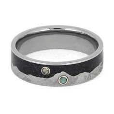 Labradorite, turquoise, and blue goldstone decorate the meteorite moonscape on this personalized wedding band from Jewelry by Johan; a design inspired and crafted from outer space. Like all of our designs, you can customize the design with unique materials to make this ring your own! RING LAYOUTRing Width: 6.5 mmRing Sleeve: TitaniumRing Profile: FlatRing Finish: Polished 0.5 mm Titanium3 mm Crushed Goldstone3 mm Gibeon Meteorite (Mountain Design) Stone: TurquoiseShape/Cut: Round, CabochonStone Mountain Wedding Band, Personalized Wedding Bands, Meteorite Wedding Band, Cosmic Design, Gibeon Meteorite, Mountain Design, Blue Goldstone, Mountain Designs, Band Jewelry