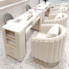 a row of white chairs sitting next to each other on top of a tiled floor