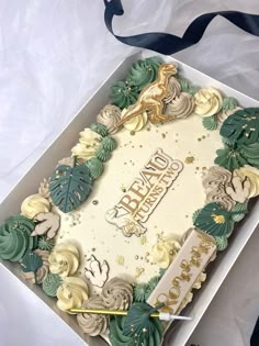 a decorated birthday cake in a box on a table