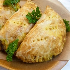 two pastries on a plate with parsley