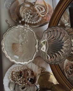 several seashells and pearls are on display in front of a mirror