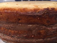 a close up of a cake with frosting on the top and brown icing on the bottom