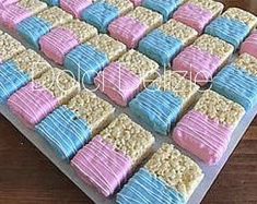 there is a cake made to look like rice krispy treats on a tray with pink and blue frosting