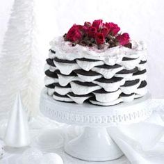 a black and white cake with red flowers on top