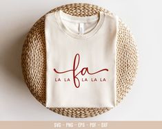 a white t - shirt with the word fa la la written in red on it