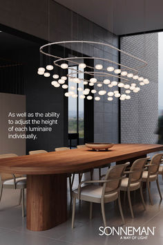 a large wooden table surrounded by chairs in front of a wall with a quote on it