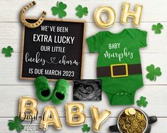 a st patrick's day baby announcement with gold letters and green onesuits