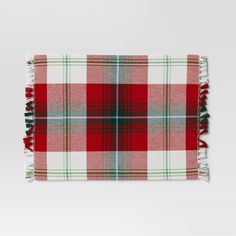 a red and green plaid blanket with fringes