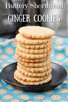 a stack of shortbread ginger cookies on a black plate with the words, buttery shortbread ginger cookies