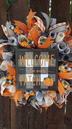 a welcome to our patch door hanger on a fence with pumpkins and ribbon