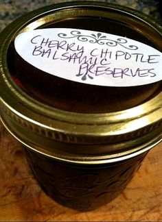 there is a jar that has some writing on the label and it says, cherry chip pottle jelly preserves