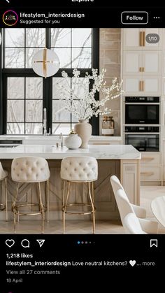 an image of a kitchen with white chairs and marble counter tops in the center island