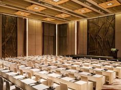 an empty conference room with long tables and chairs set up for a formal function or meeting