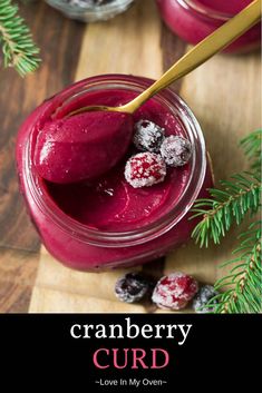 cranberry curd in a jar on a cutting board with berries and pine branches