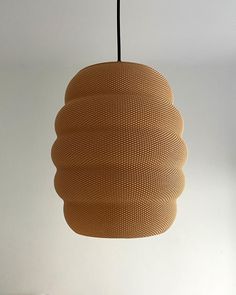 a light fixture hanging from the ceiling in a room with white walls and flooring