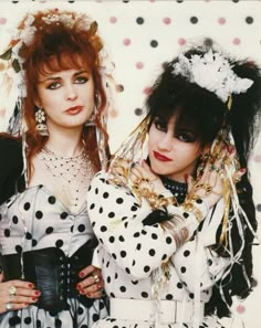 two women dressed in costume posing for a photo