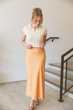 Elevate your wardrobe with our Apricot Midi Skirt. This silky, high-waisted skirt features a convenient side zip for easy wear. With its elegant apricot hue, this midi skirt will add a touch of sophistication to any outfit. Perfect for any occasion, it's a must-have for any fashion-forward individual. Side zipper fitted no stretch Approx. 13.25" length Polyester/spandex Hand wash 97% polyester 3% spandex Model is wearing a medium Chic Rayon Lined Skirt, Rayon Midi Maxi Skirt For Day Out, Chic Relaxed Fit Maxi Skirt In Rayon, Chic Relaxed Maxi Skirt In Rayon, Chic Flared Maxi Skirt In Rayon, Chic Relaxed Rayon Skirt, Chic Beige Lined Maxi Skirt, Chic Rayon Lined Maxi Skirt, Elegant Orange Skirt For Work