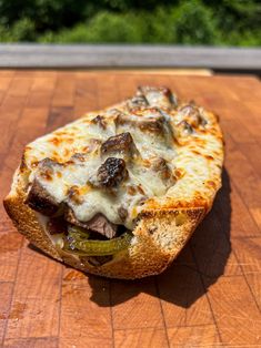 a pizza sitting on top of a wooden cutting board