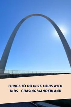 the st louis with kids - chasing wanderland sign in front of a large arch