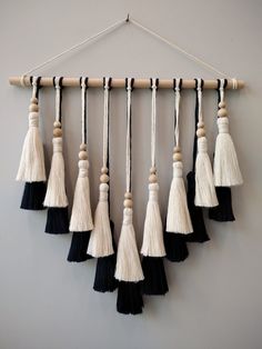 black and white tassels hanging on a wall