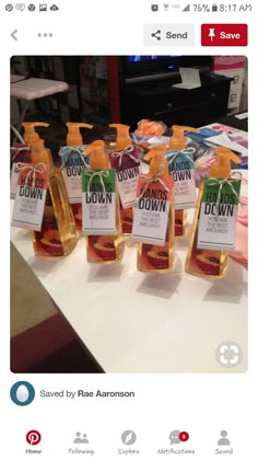 several bottles of hand sanitizers sitting on top of a table with labels in front of them