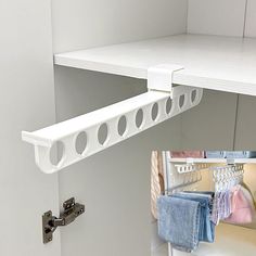 there is a white shelf with some towels hanging on it and an image of the inside of a closet