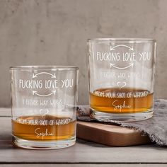 two personalized whiskey glasses sitting next to each other