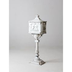 a white pedestal with a clock on it