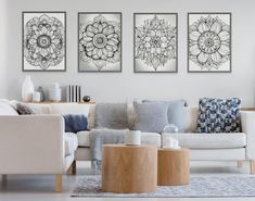 three black and white floral prints on the wall above a couch in a living room