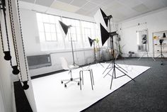 an empty studio with black and white photography equipment