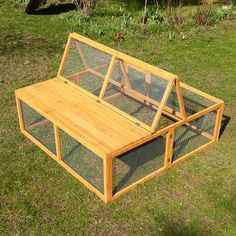 a wooden bench sitting on top of a lush green field