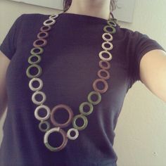 a woman wearing a necklace made out of circles