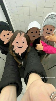 four people with faces drawn on their bodies are standing in front of a bathroom mirror