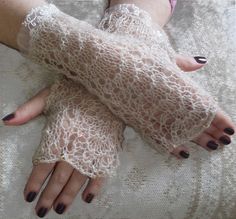 a woman's hands with white lace on them