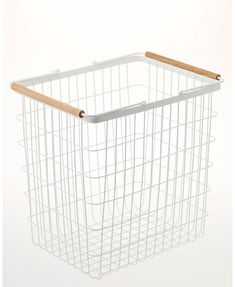 a white wire basket with wooden handles on the front and bottom, against a white background