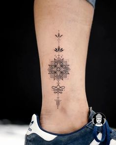 a woman's foot with a flower tattoo on the lower part of her leg