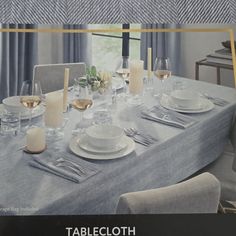 the table cloth has been set with white plates and silverware