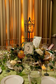 the table is set with plates, silverware and place settings for an elegant dinner