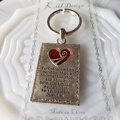 a metal keychain with a heart and poem on it sitting on a plate