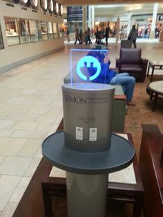 a person sitting on a bench in a mall